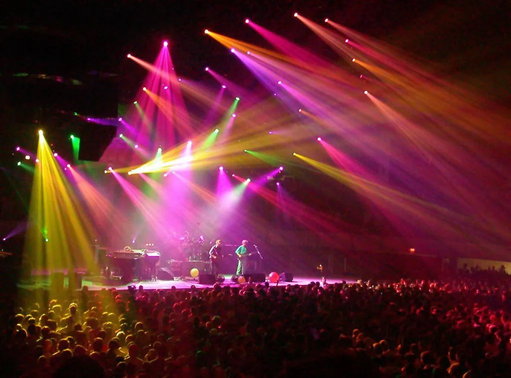 Concert stage with multicolored beams of light over the audience
