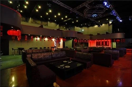 Lounge seating beneath a suspended event lighting rig