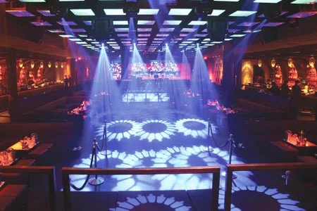 Dance floor with white projected patterns and blue light beams
