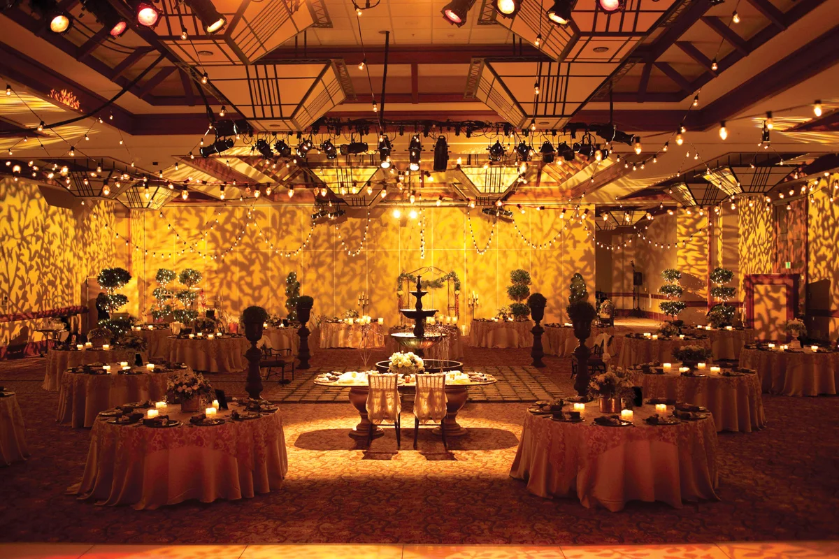 Reception space with golden lighting and projected foliage patterns