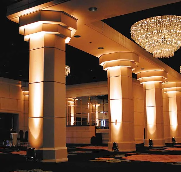 Venue columns illuminated with warm architectural uplighting