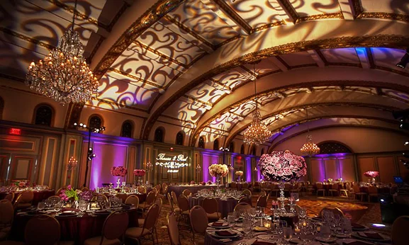 Ballroom with patterned ceiling projections and purple uplighting