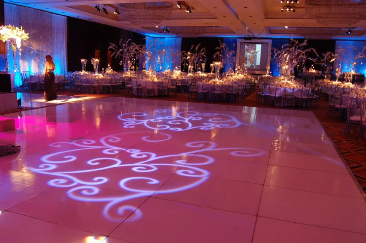 Reception dance floor with projected patterns and pink and blue lighting