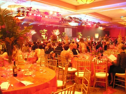 Guests at a banquet with warm orange event lighting