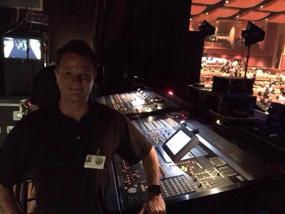 Michael Chasteen working behind the scenes at an event mixing console